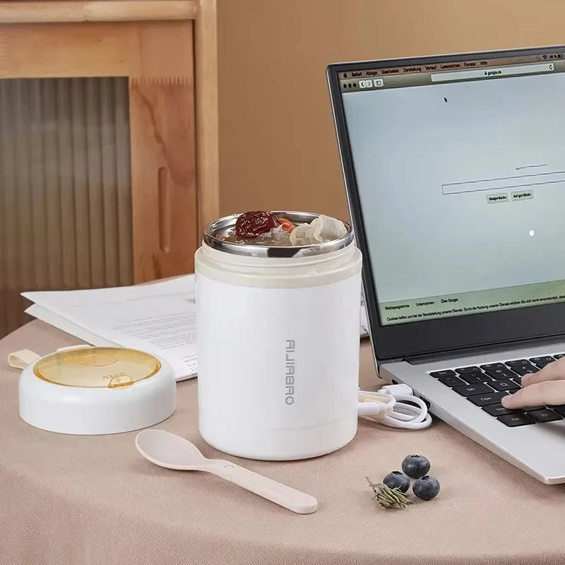 White thermos with food on a desk next to a laptop